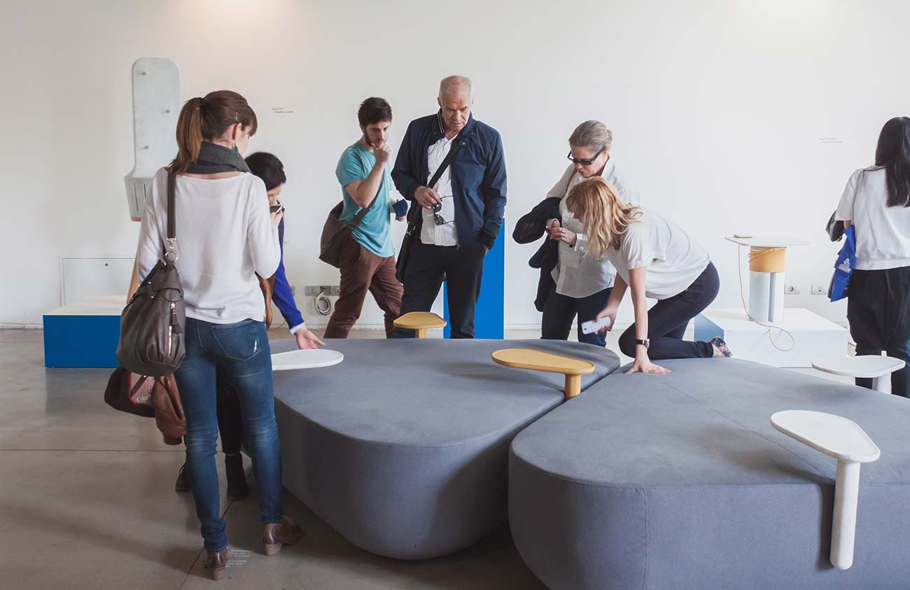 People standing around a table discussing ideas, creating an interior design Ras al Khaimah setting