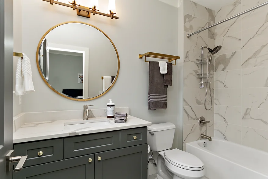 Luxurious bathroom using mixing metals in interior design for a modern and cohesive style.